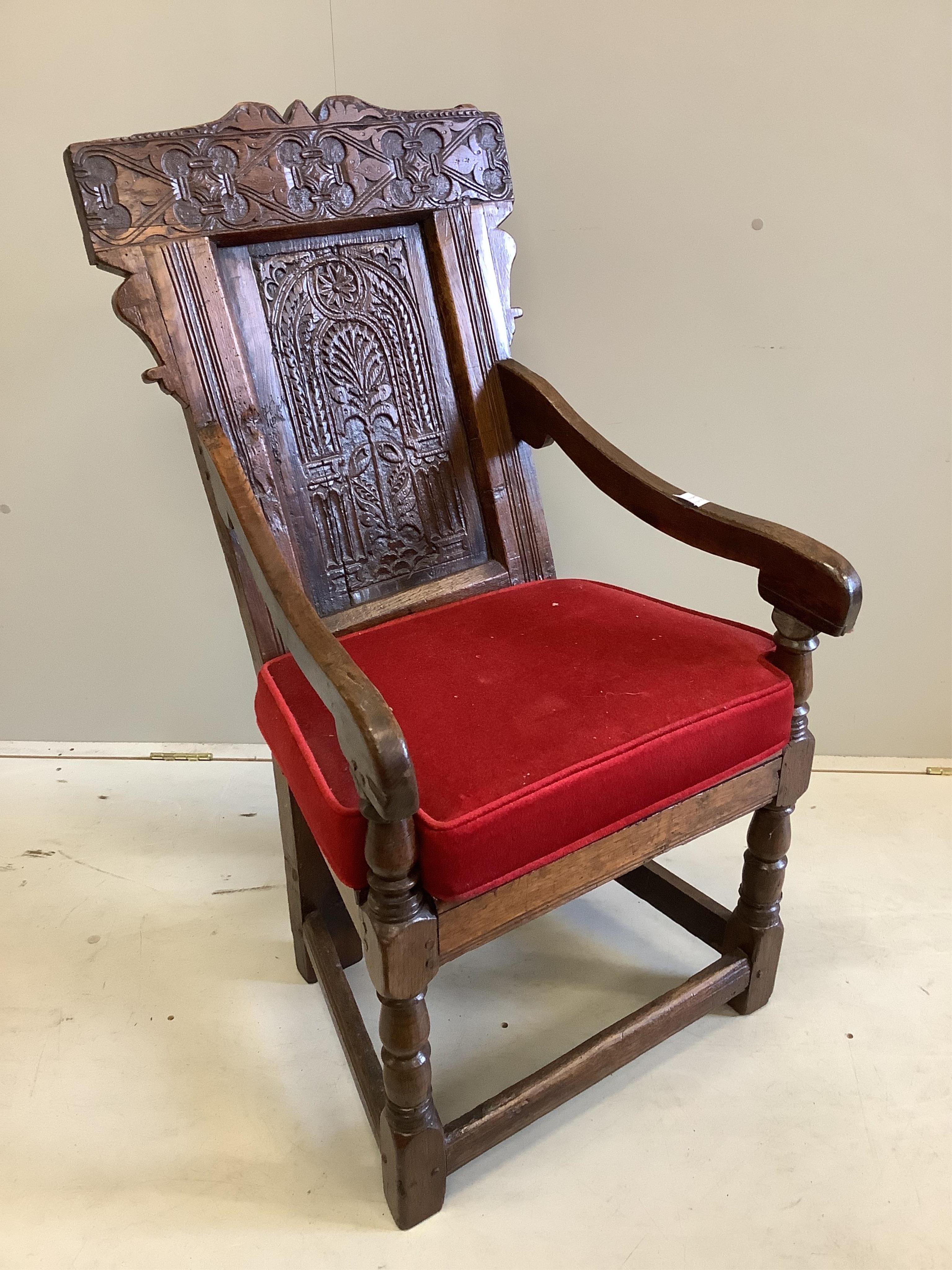 A 17th century carved oak wainscot elbow chair, width 57cm, depth 52cm, height 105cm. Condition - fair